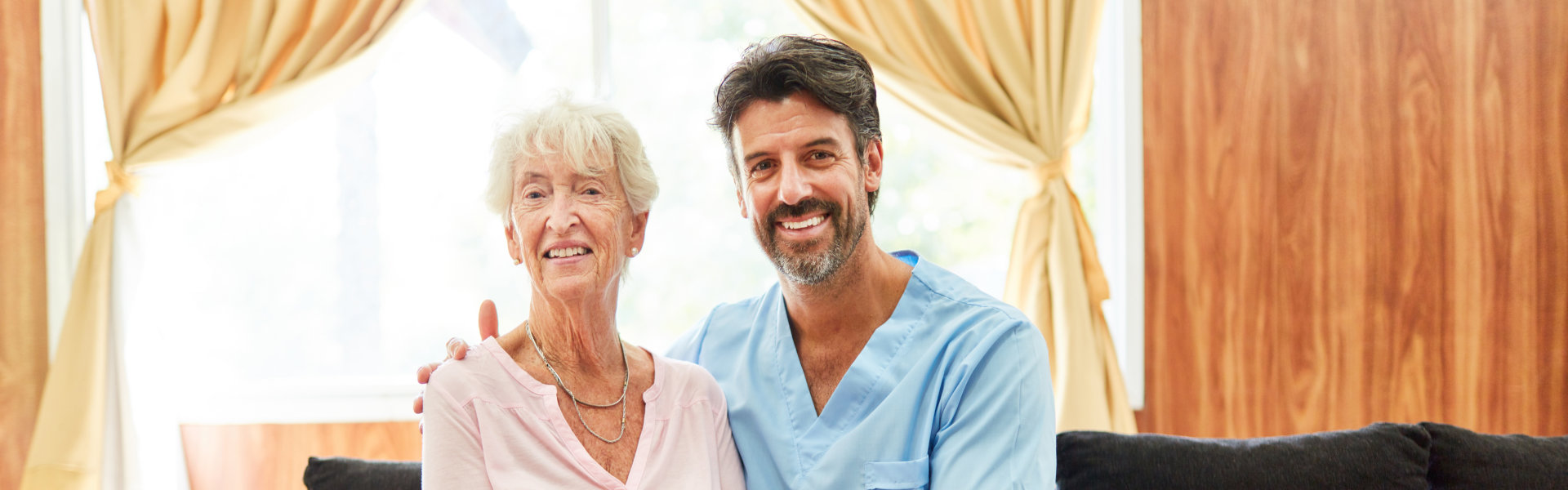 aide and elderly woman smiling