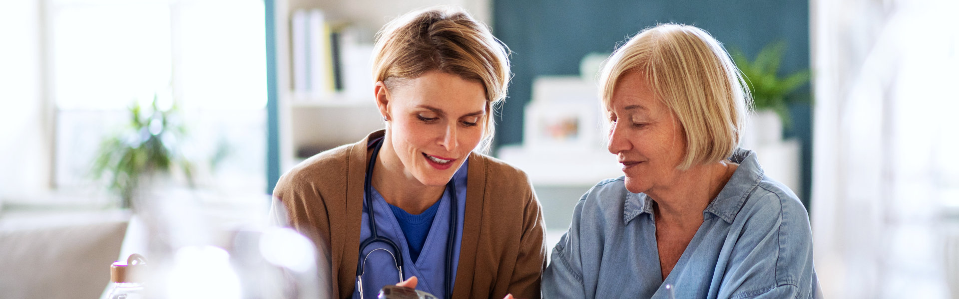 nurse and elderly woman talking